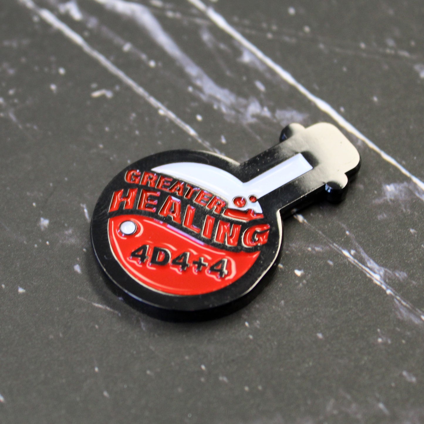 Potion of Greater Healing token on a black surface with white streak design.