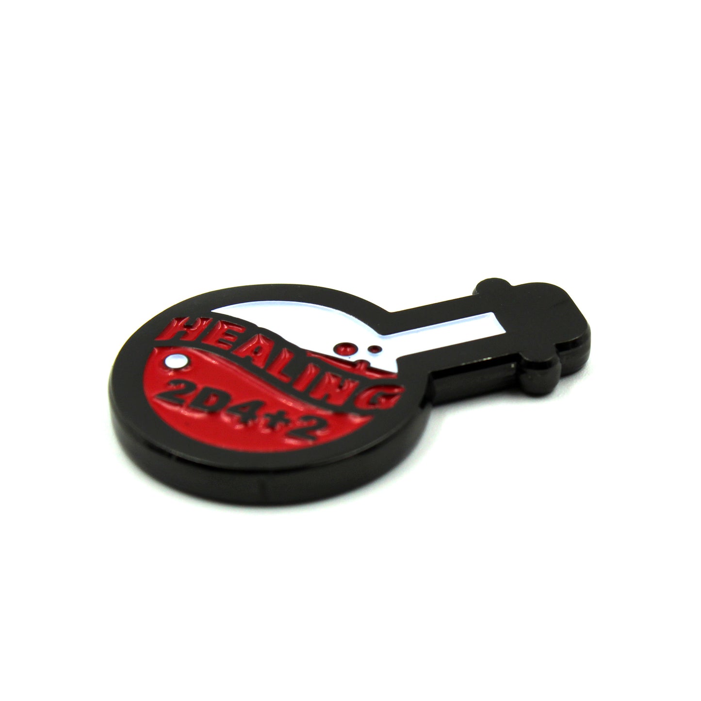 A potion-bottle-shaped token with black edges and white and red enamel inlay and the text "Healing 2D4+2" on a white background.