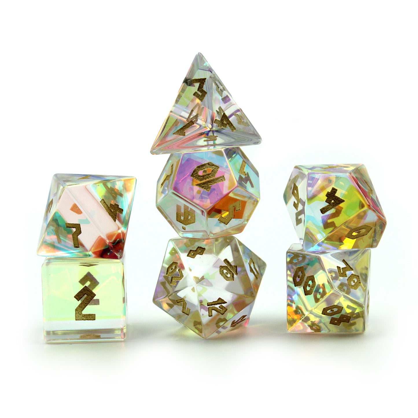 Prismatic Glass dice set with a chiseled font arranged in 3 columns on a white surface and background.