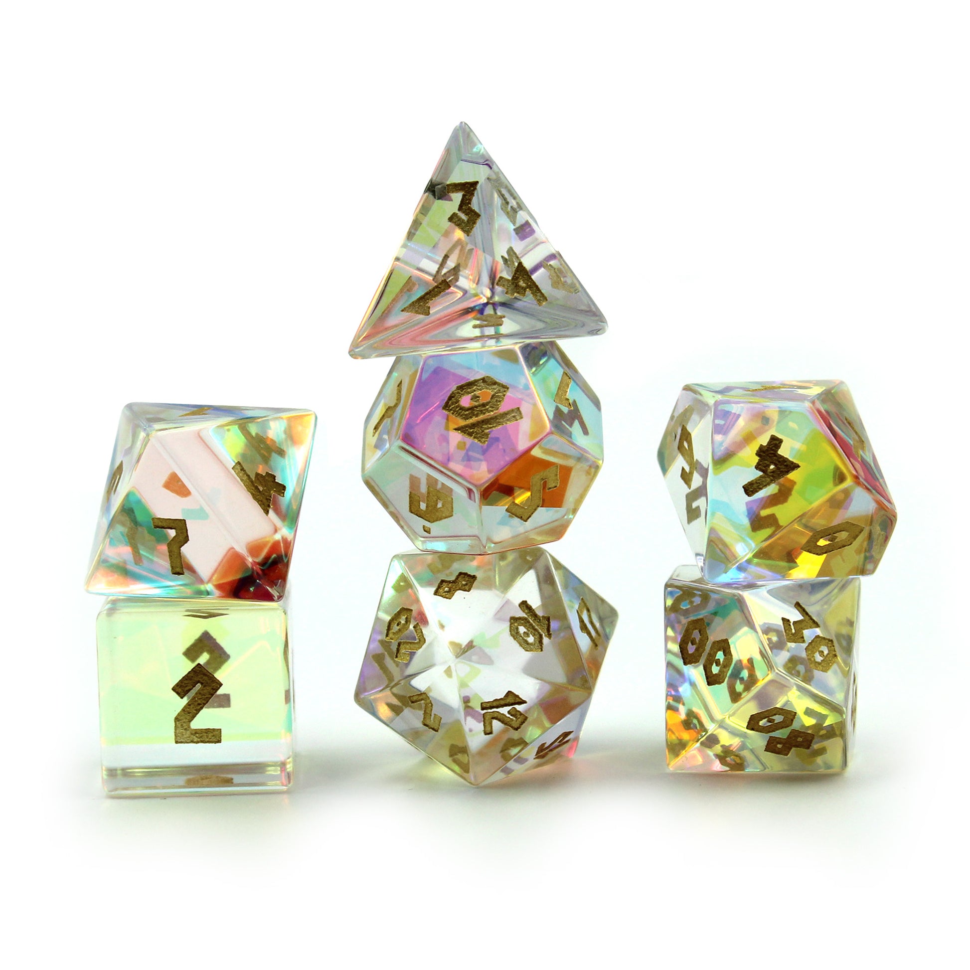 Prismatic Glass dice set with a chiseled font arranged in 3 columns on a white surface and background.