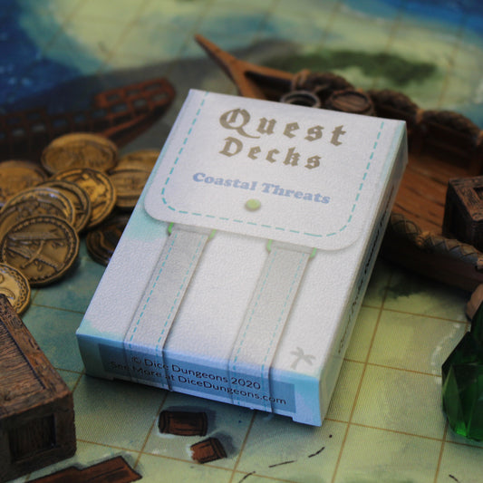 Coastal Threats deck box on a cloth map leaning on a boat miniature with Dice Dungeons Character Coins on the left.  The Coastal Threats Quest Decks set is filled with adventures for coastal regions and seafaring campaigns.