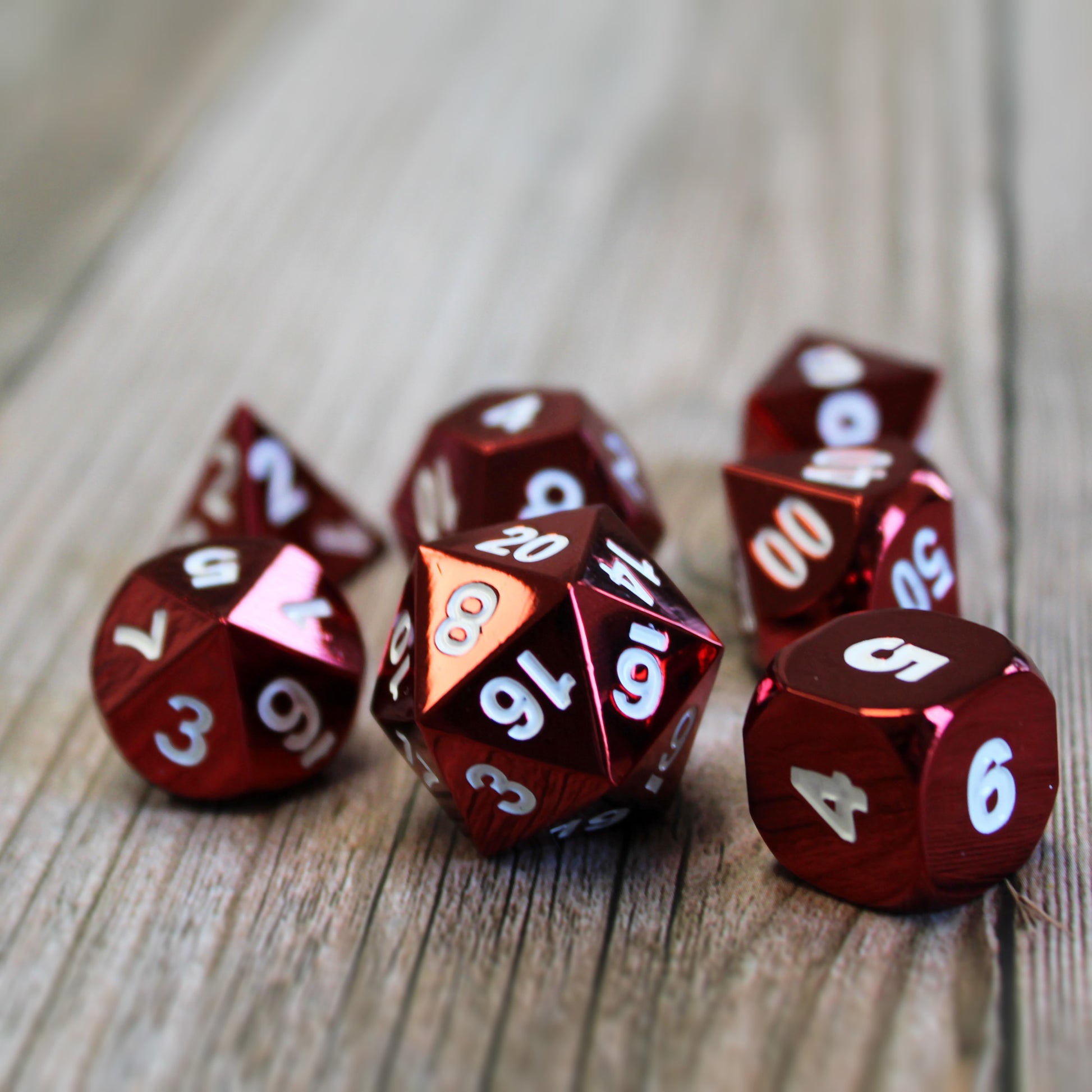 Radiant red dice set scattered on a light wooden surface