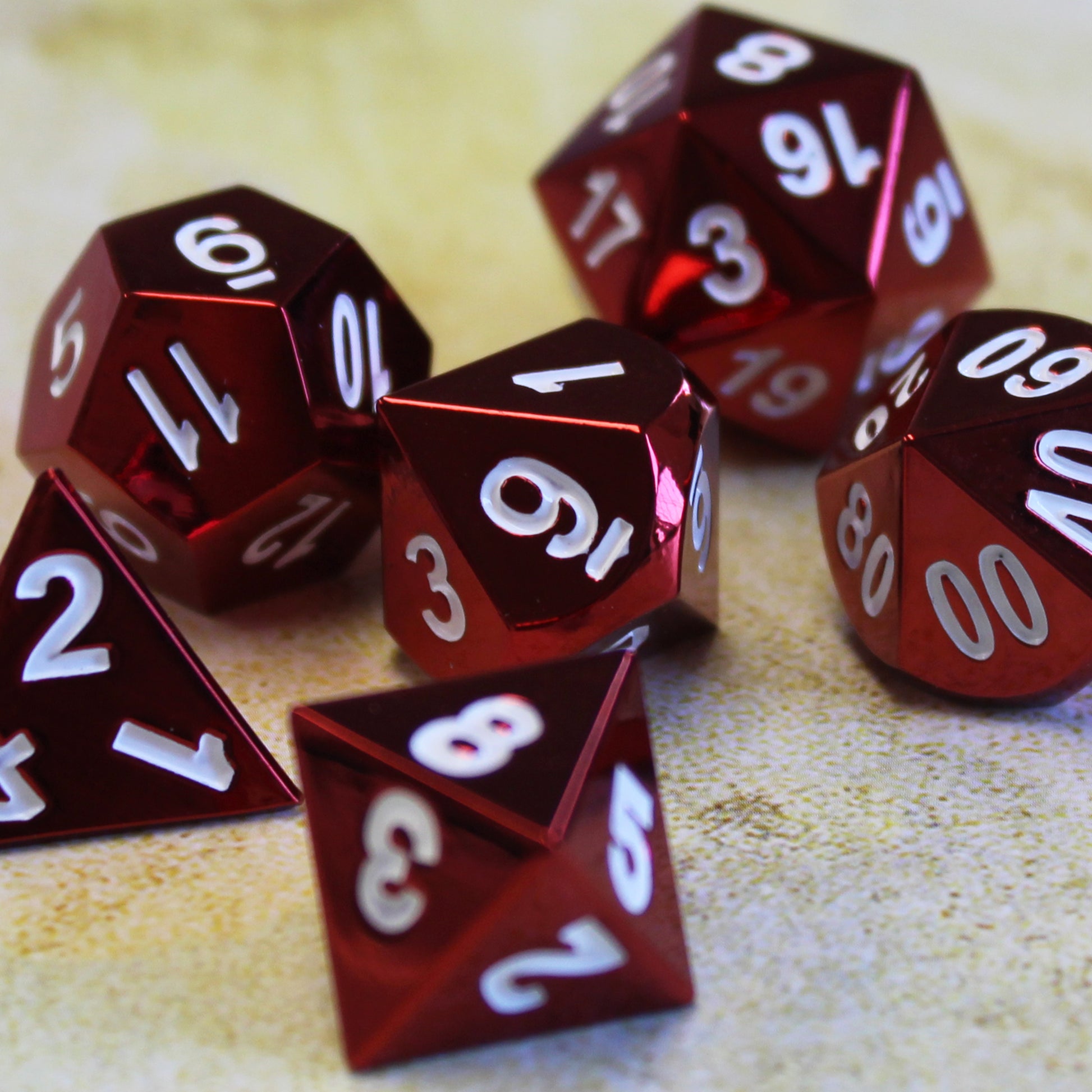 Close-up of Radiant red dice set on a green play mat. The close-up showcases the shiny red faces and white numbering