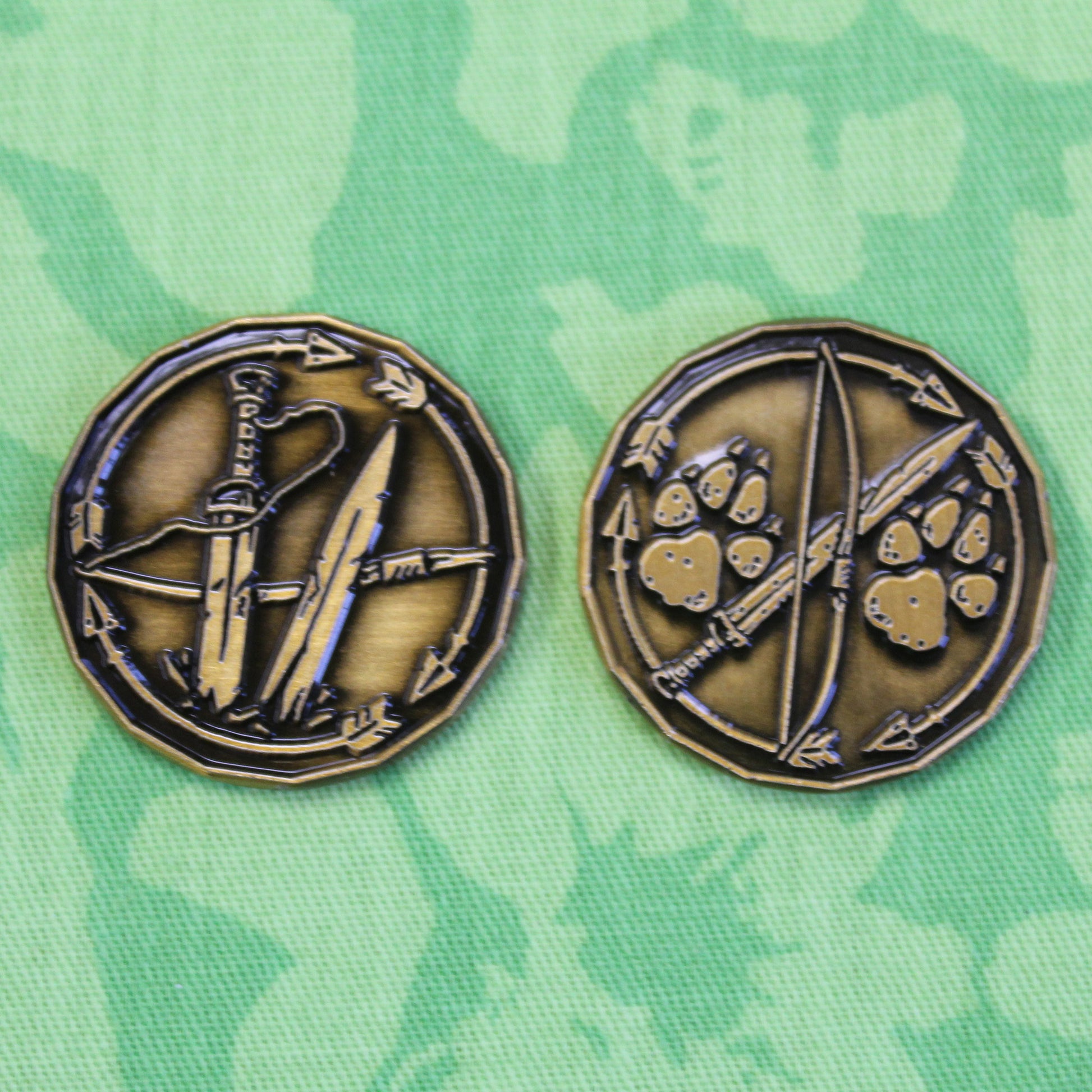 Two golden ranger character tokens sitting on a green play mat