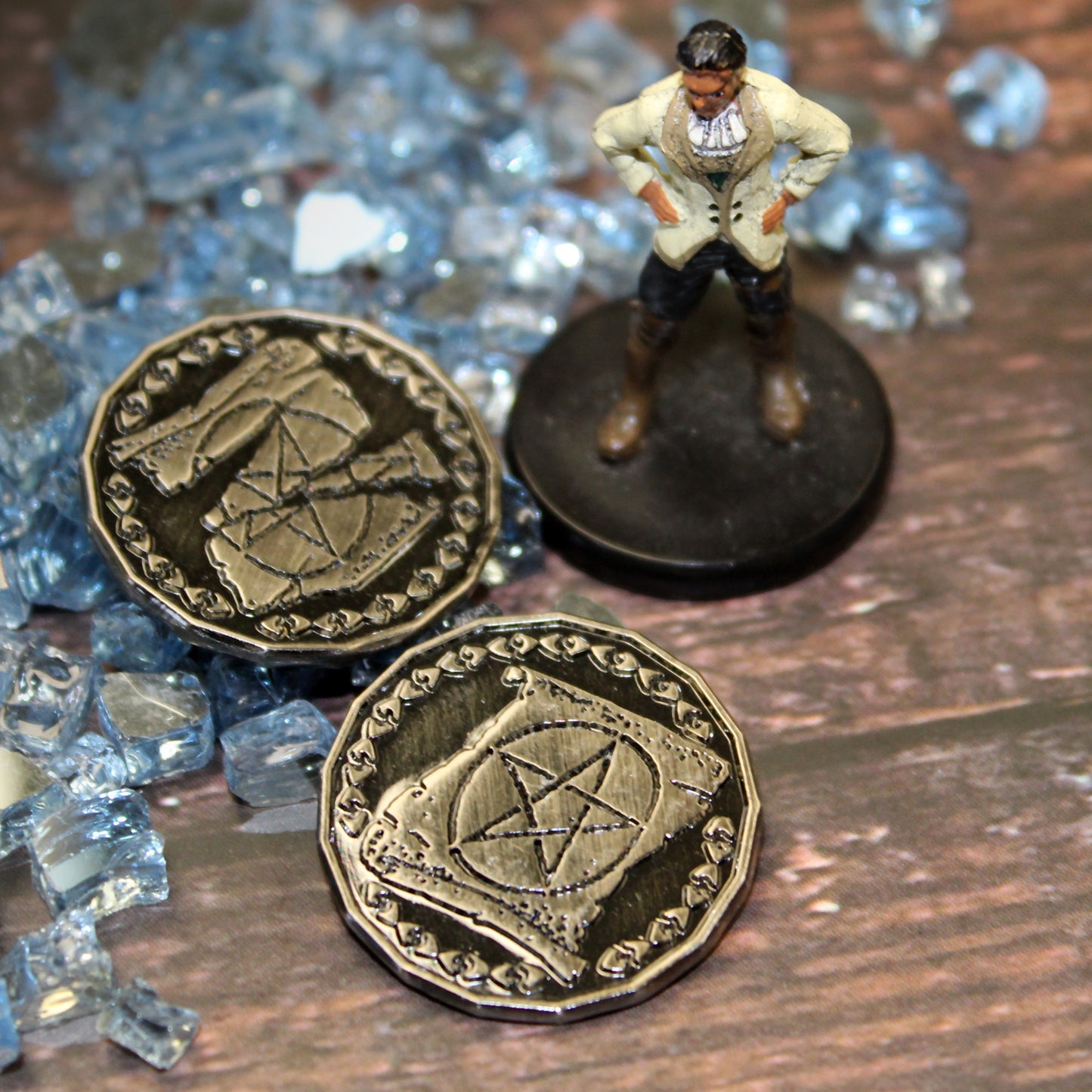 Two Silver Warlock Tokens with a Mini Figure on a Wood Background