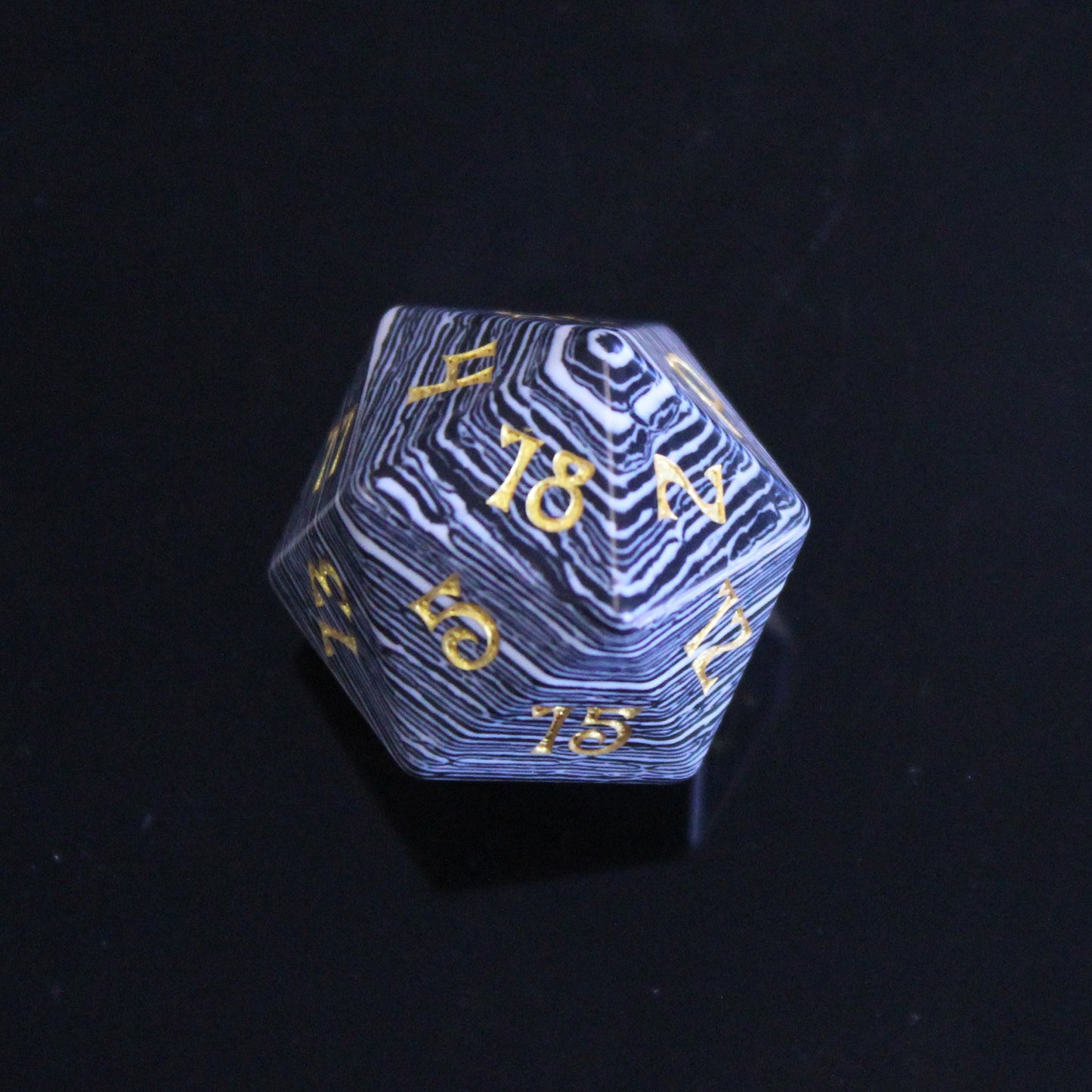 Single 20-Sided Die with Black and White Stripes and Gold Numbering