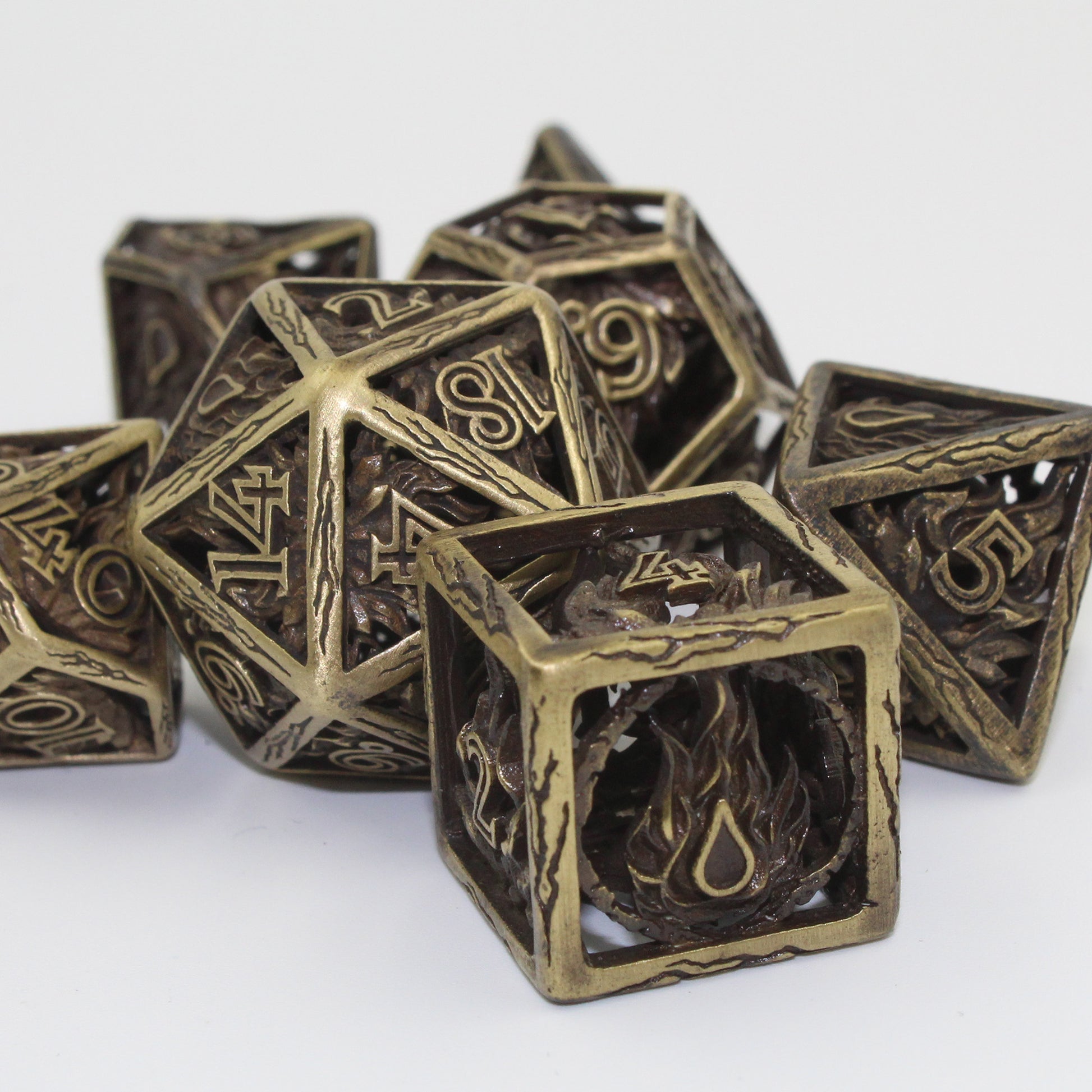 five dice in focus with two other dice blurred in background, all on a white background
