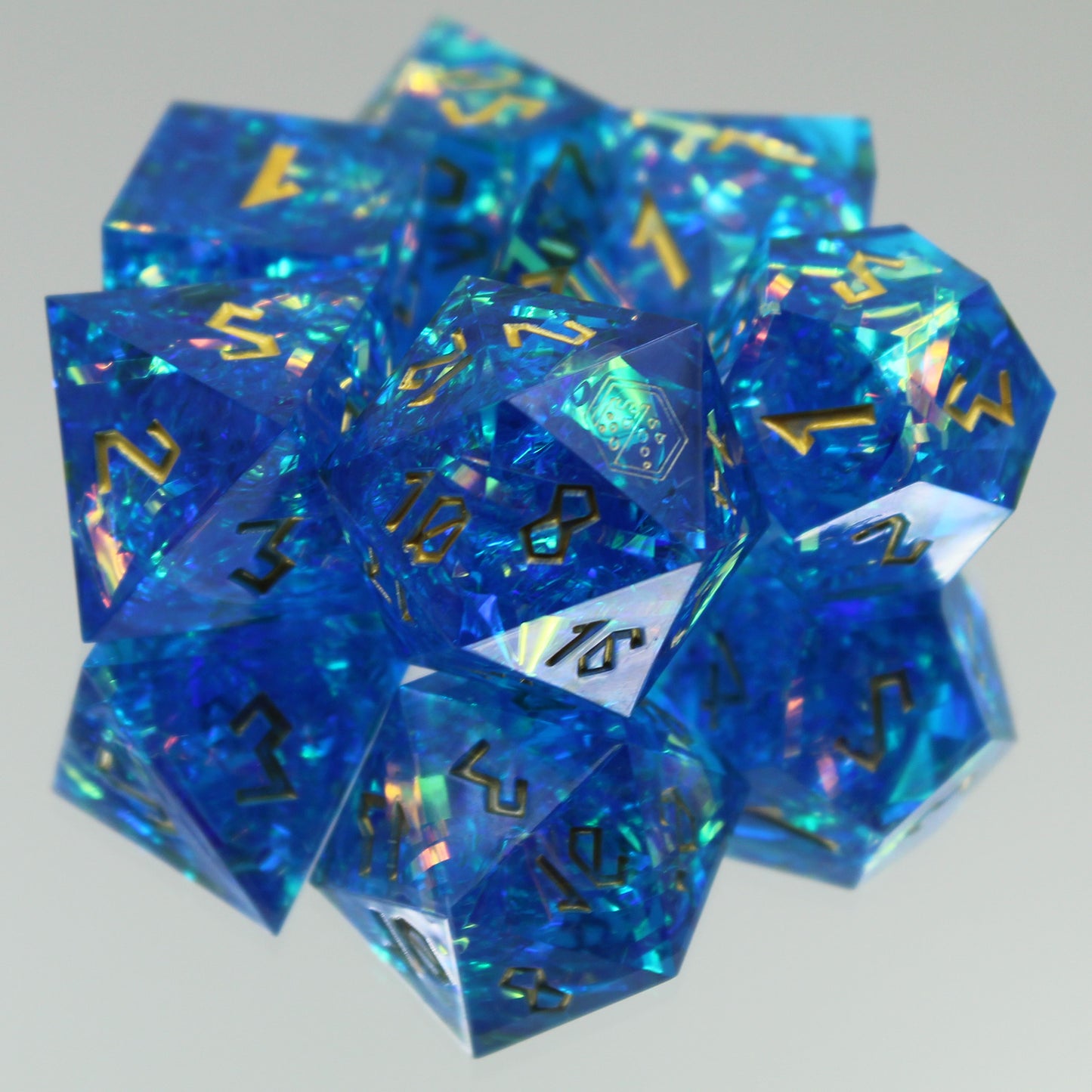 StarGlow blue dice arranged in a pile on a gray surface.