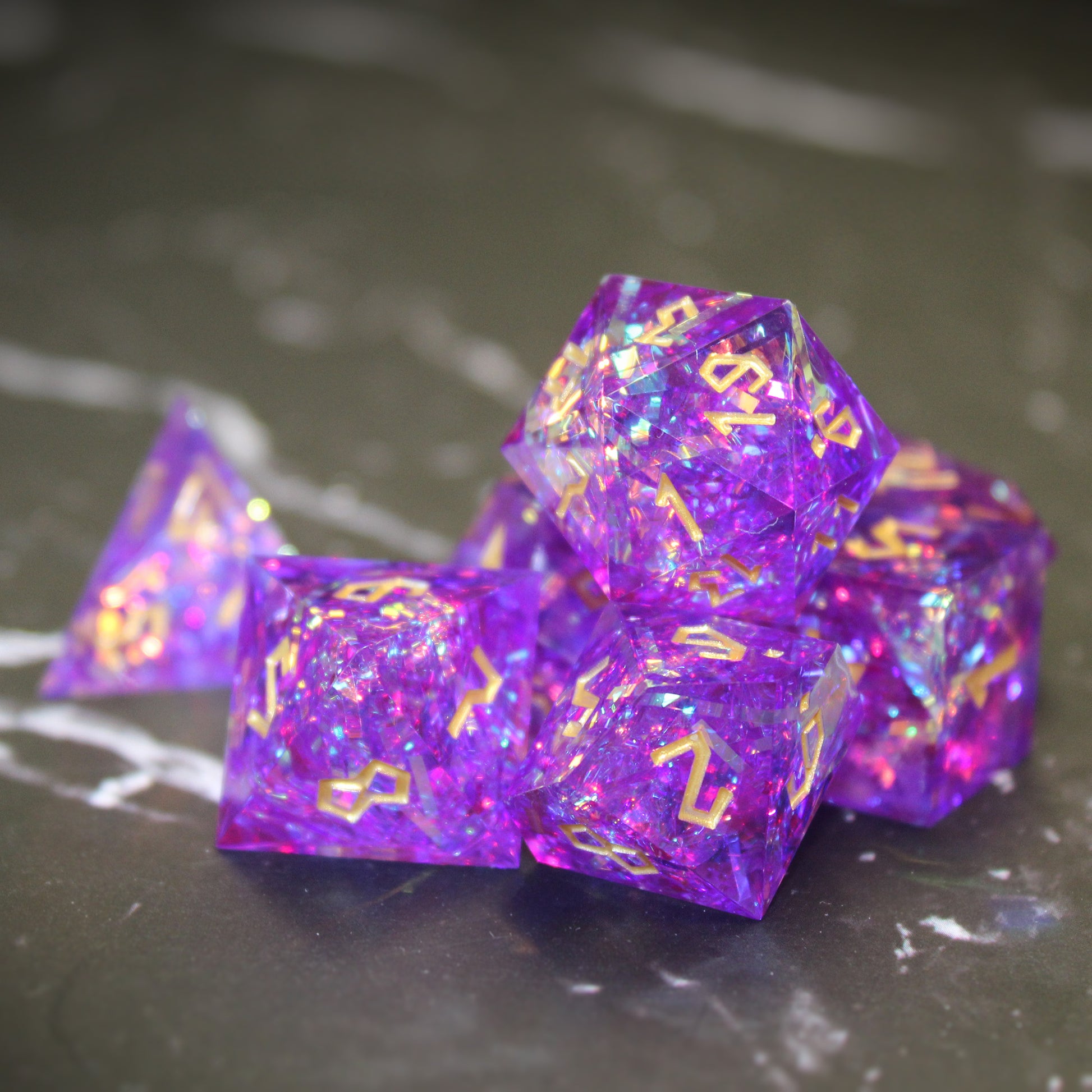 Closeup of StarGlow Purple dice set on a black surface with white streaking pattern.