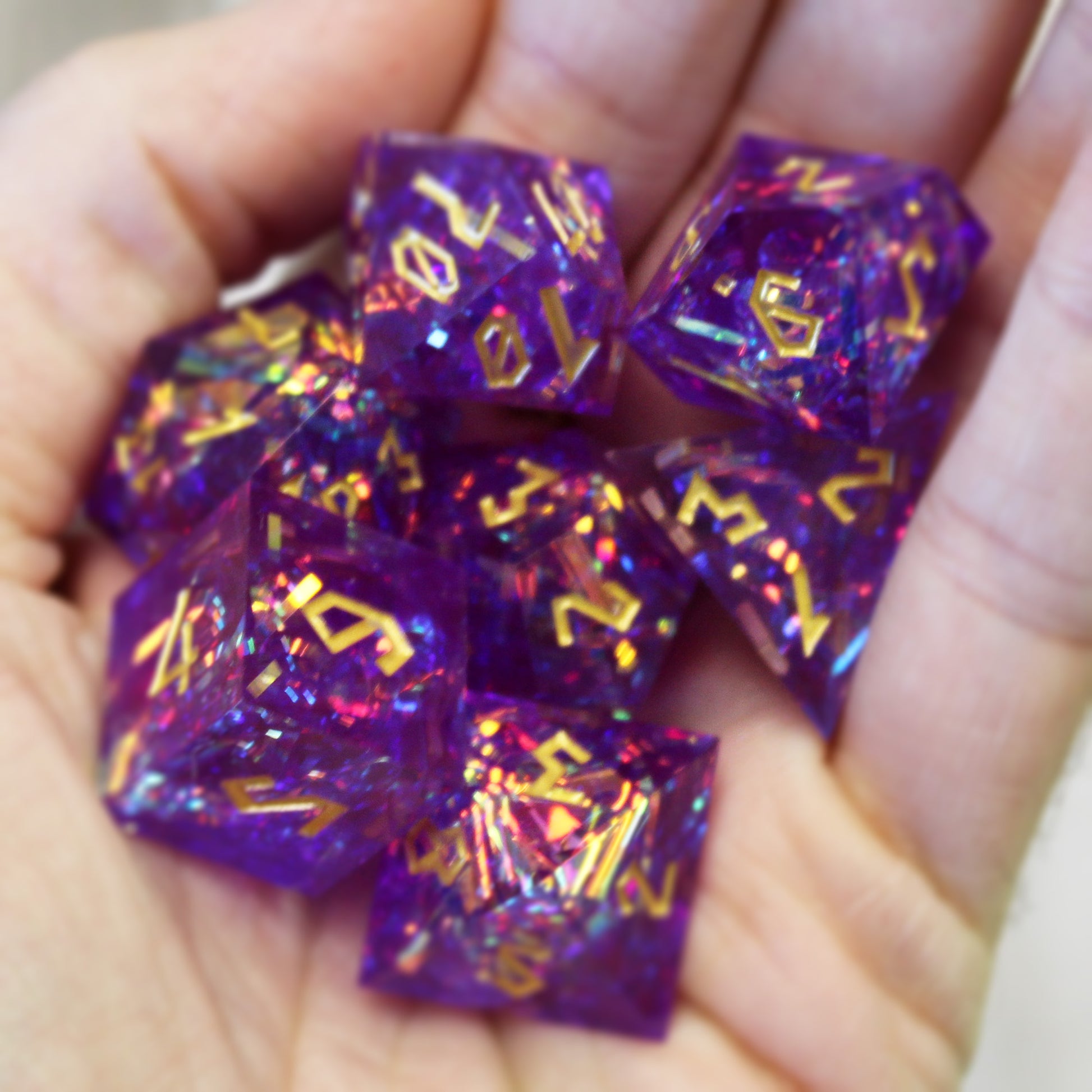 StarGlow Purple dice set arranged in a pile in the palm of someone's hand.