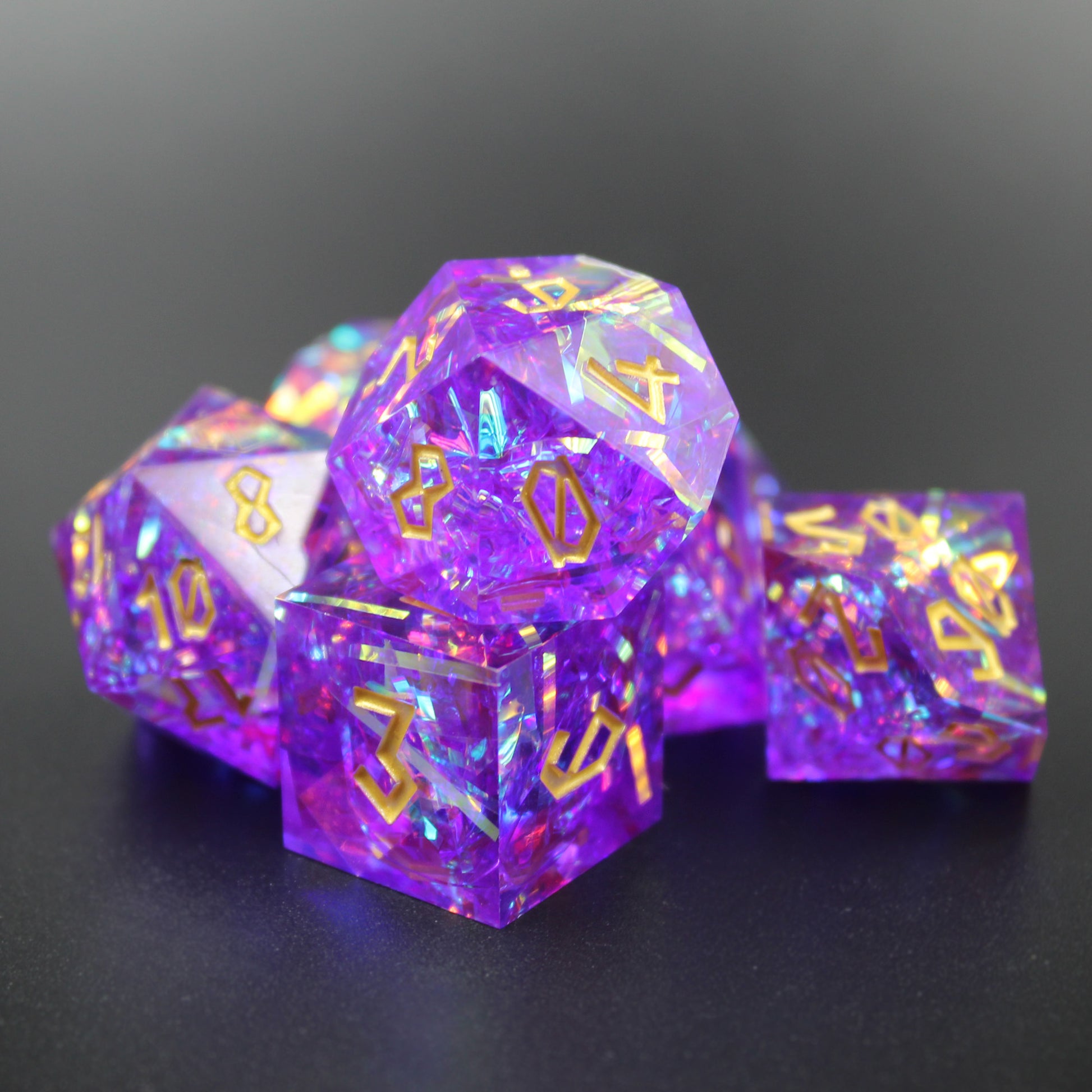 StarGlow purple dice set arranged in a pile on a gray background.