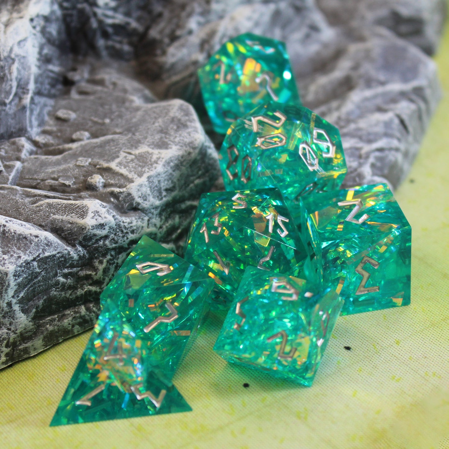 Green sharp edged resin dice, handmade with silvery inclusions of mylar foil.