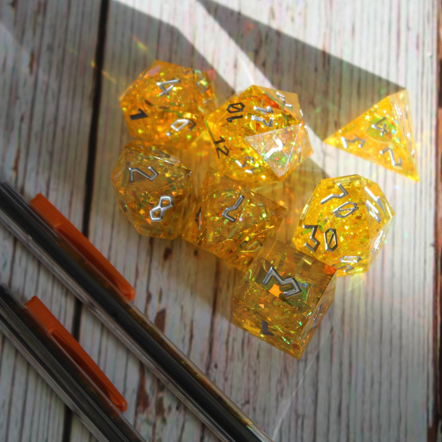 StarGlow Yellow dice set under natural light from a window, ready for use in a Dungeons & Dragons session.