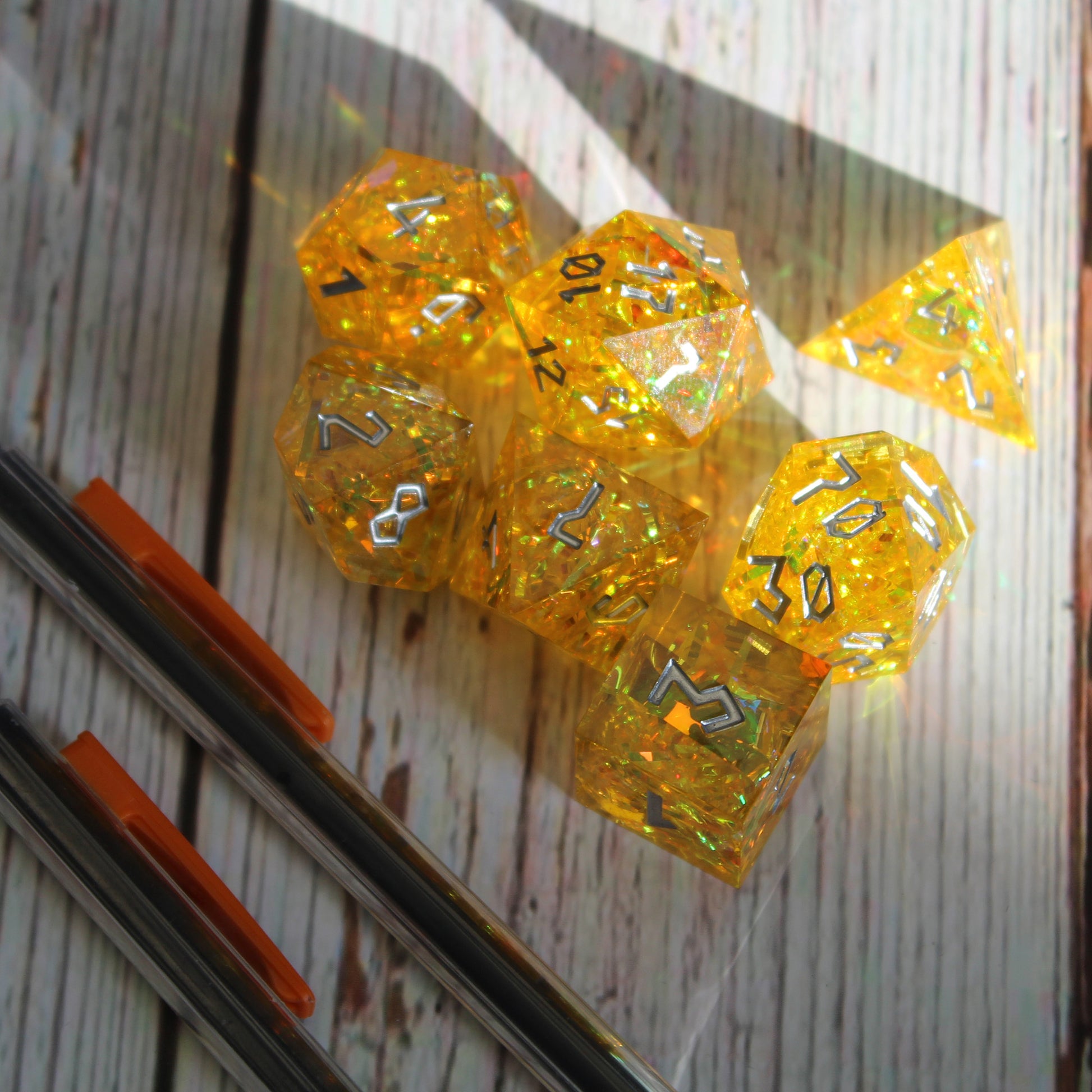 StarGlow Yellow dice set under natural light from a window, ready for use in a Dungeons & Dragons session.