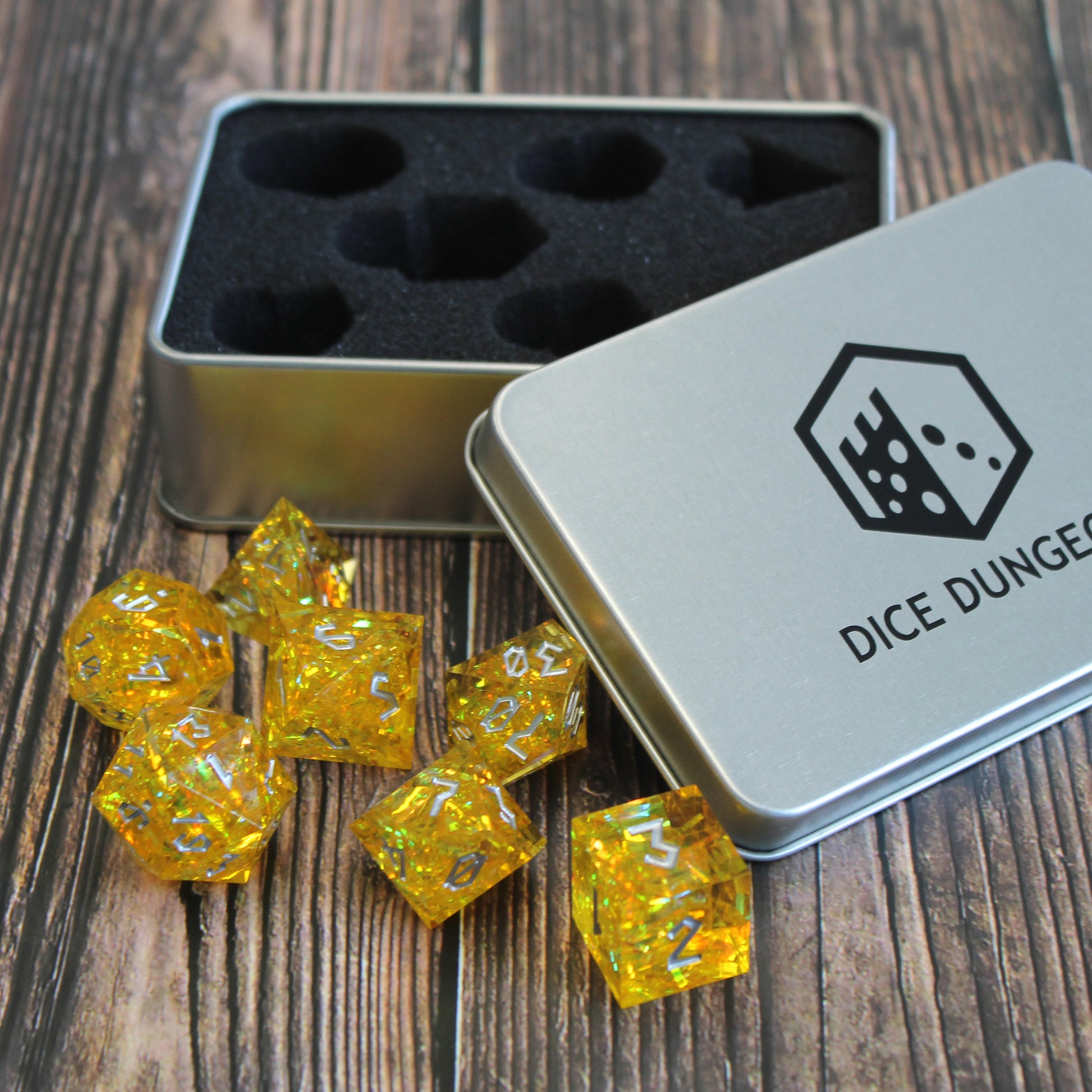 StarGlow Yellow sharp edge resin dice set shown with its display box, highlighting the vibrant colors and sharp-edged design.