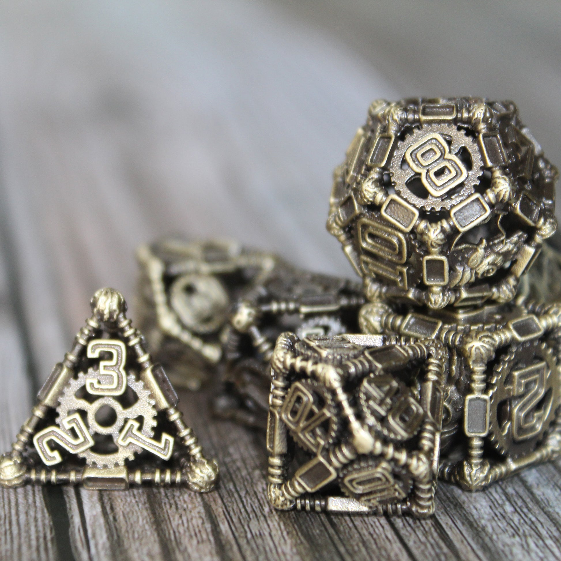 Four dice in foreground, with other dice blurred in background. All on wood paneled surface.