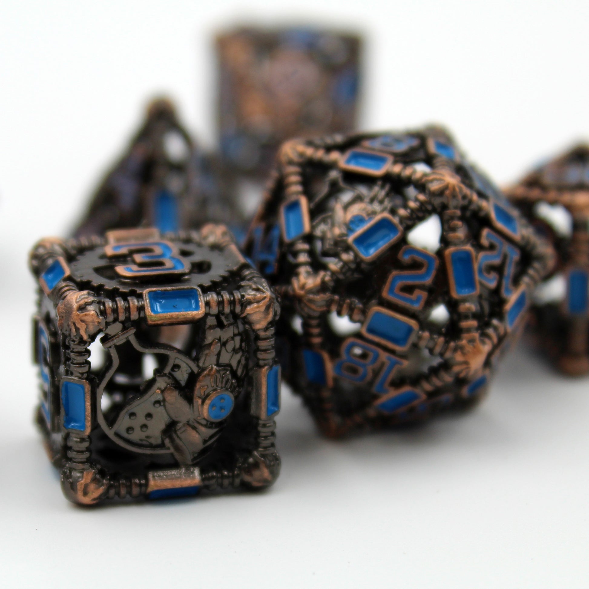 6 sided and 20 sided dice in foreground, with other dice blurred in background. All on a white background.