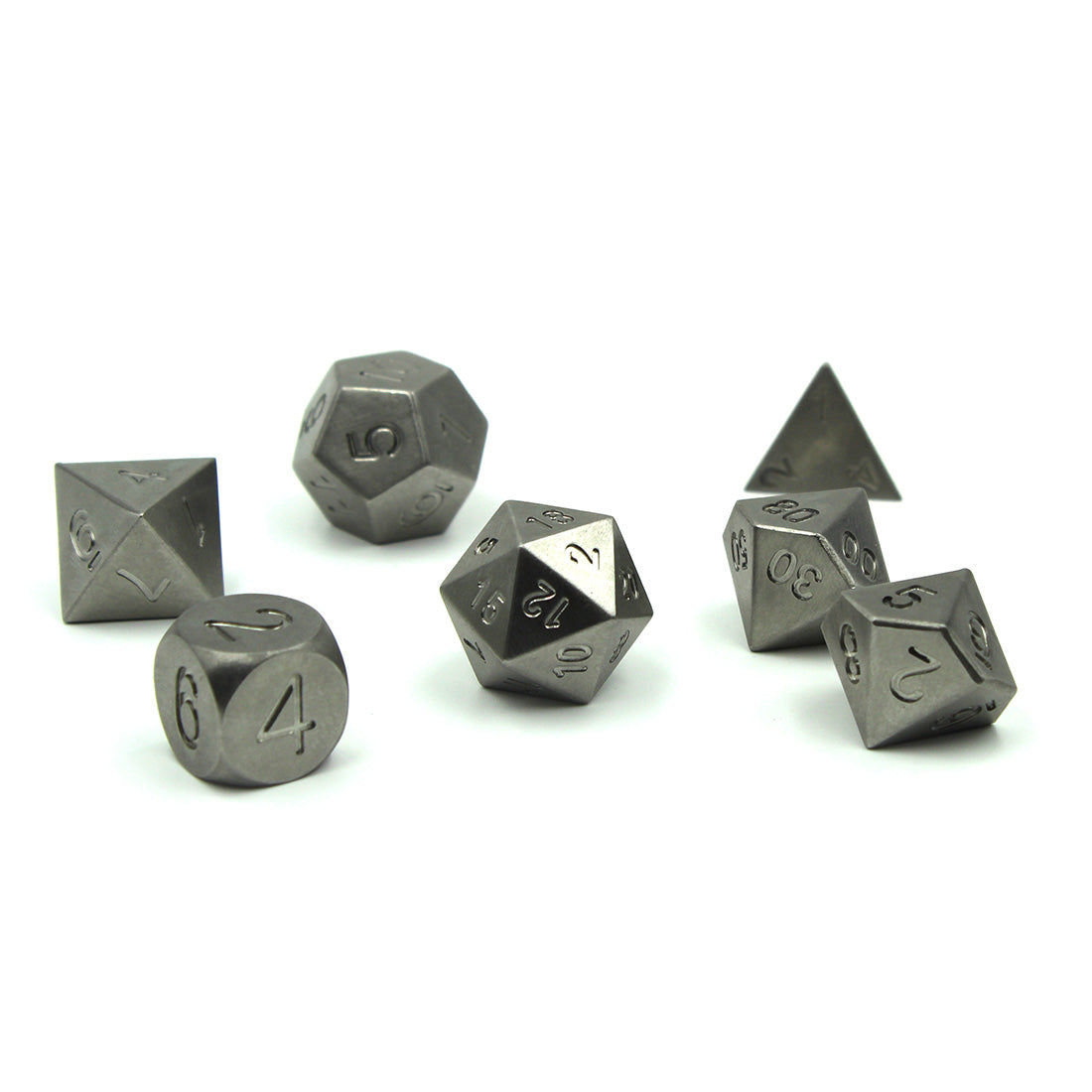 Metal Tungsten Dice Set on a white surface with overhead lighting. This set has no electroplating or inking to showcase the third heaviest solid metal in the world.