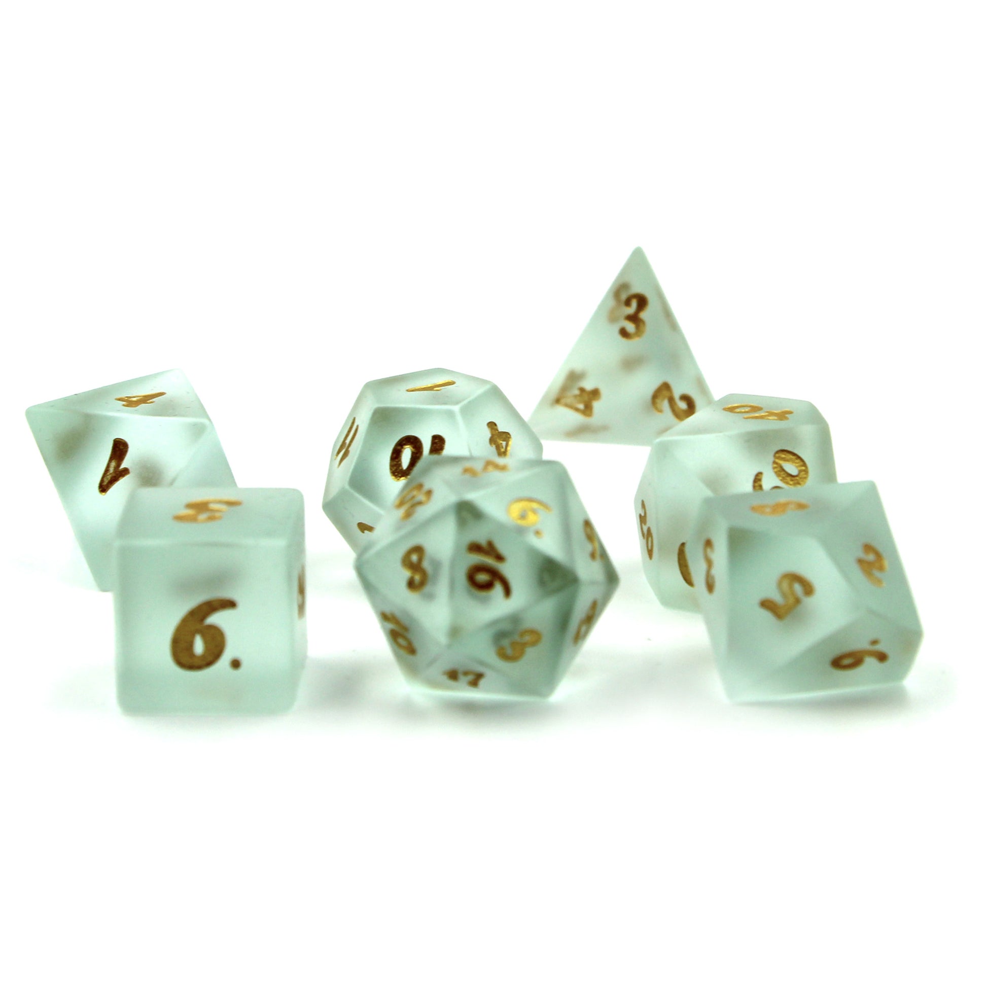 Set of Powder Blue Frosted Glass Dice with Gold Numbering Scattered on a White Background