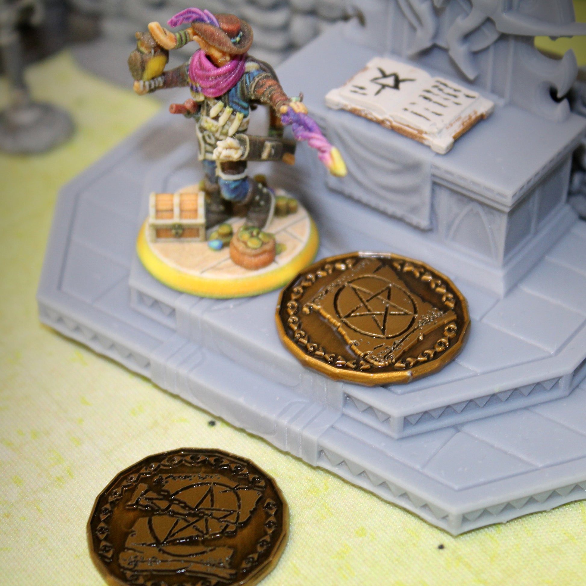 Two Gold Warlock Tokens on a Battle Map with a Mini Figure
