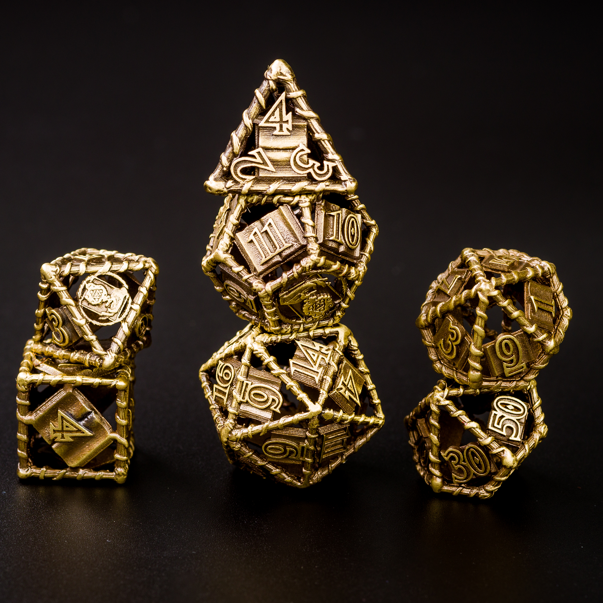 All 7 gold dice piled up in 3 stacks. Two dice in first stack, three dice in second stack, two dice in third stack. All on a black background.