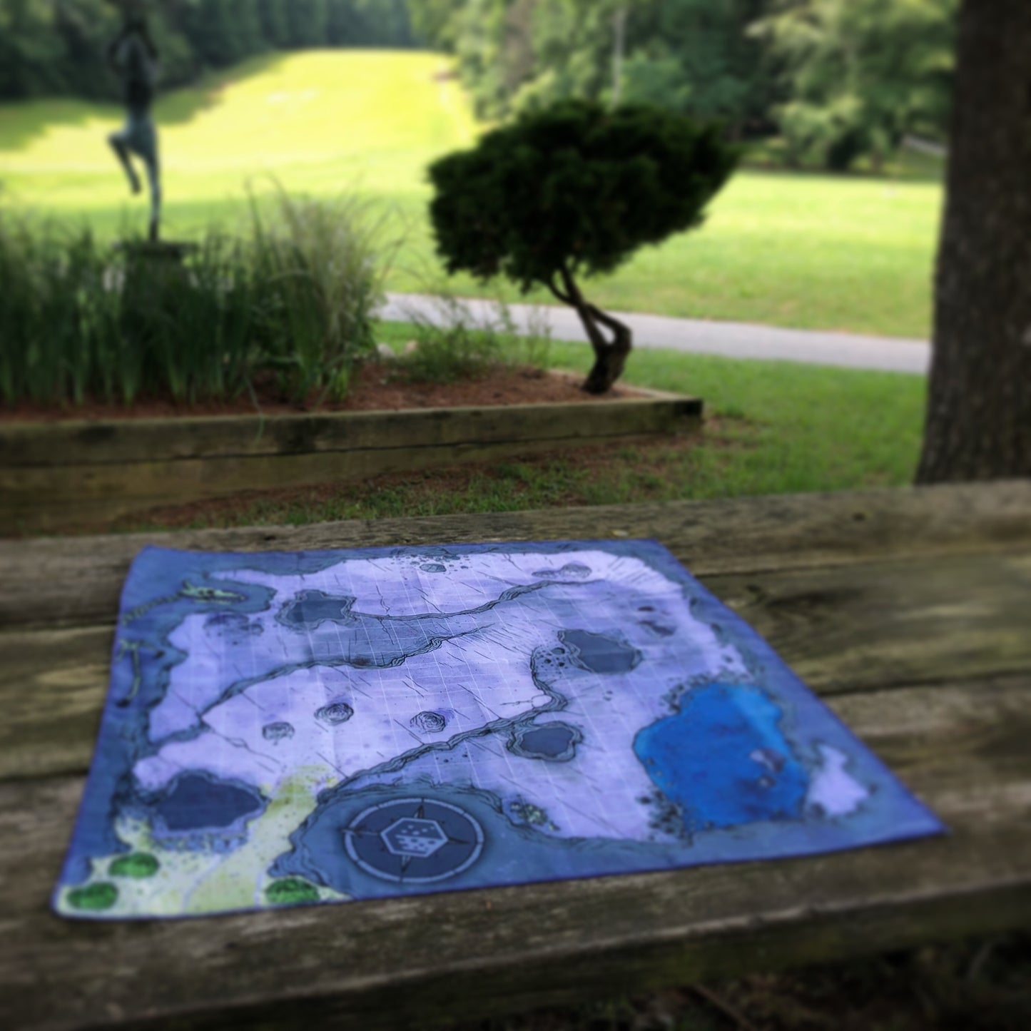 Photo of a cave battle map on an outdoor picnic table