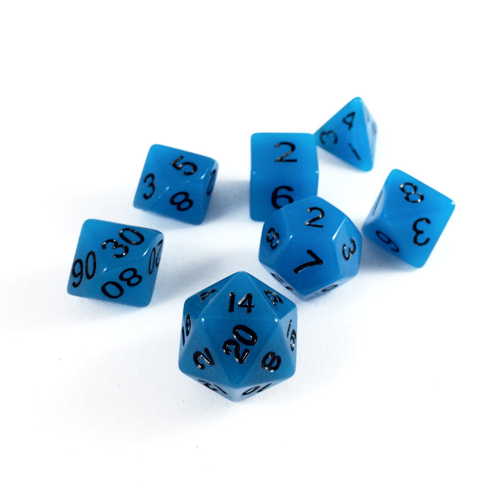 Glow in the Dark blue dice scattered on a white background