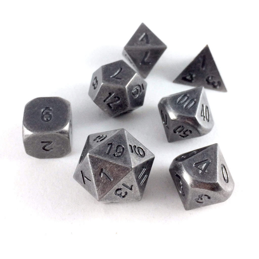 Primordial silver dice set scattered on a white background