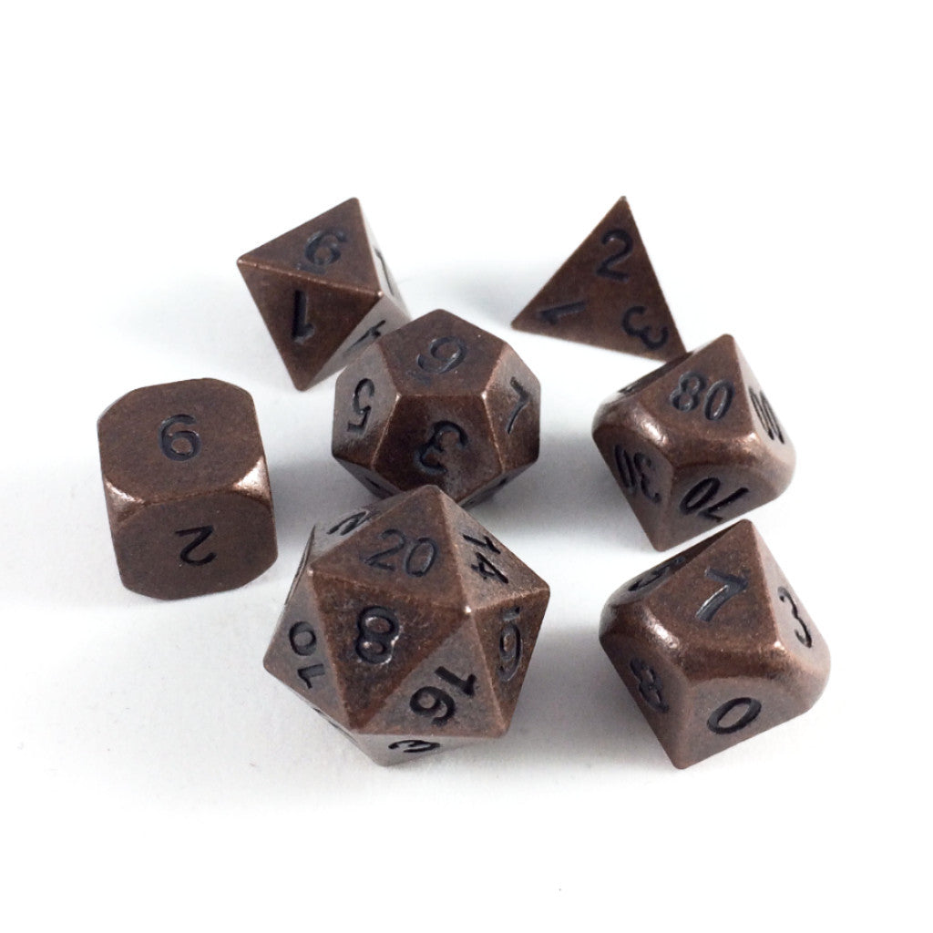Primordial copper dice set arranged in a circle with the D12 in the center and the rest of the dice surrounding it, on a white background