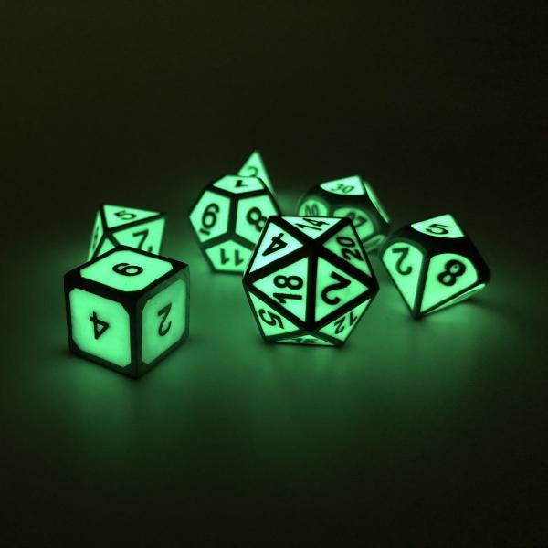 Metal Imperial Glow in the Dark dice set in the dark, showcasing the glowing green faces on each die.
