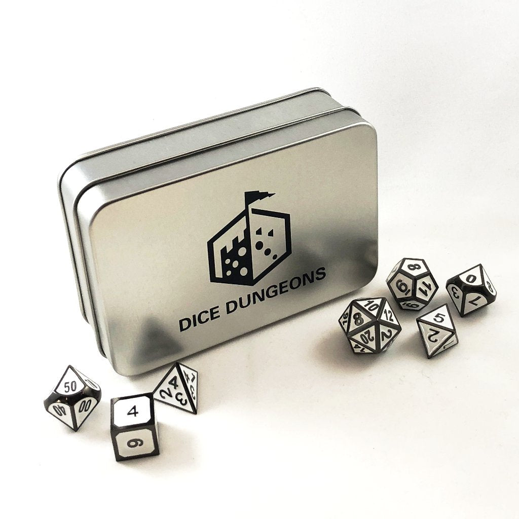 Looking down at the Imperial White dice set scattered on a white background, with the Dice Dungeons silver display box standing up between the two dice piles.