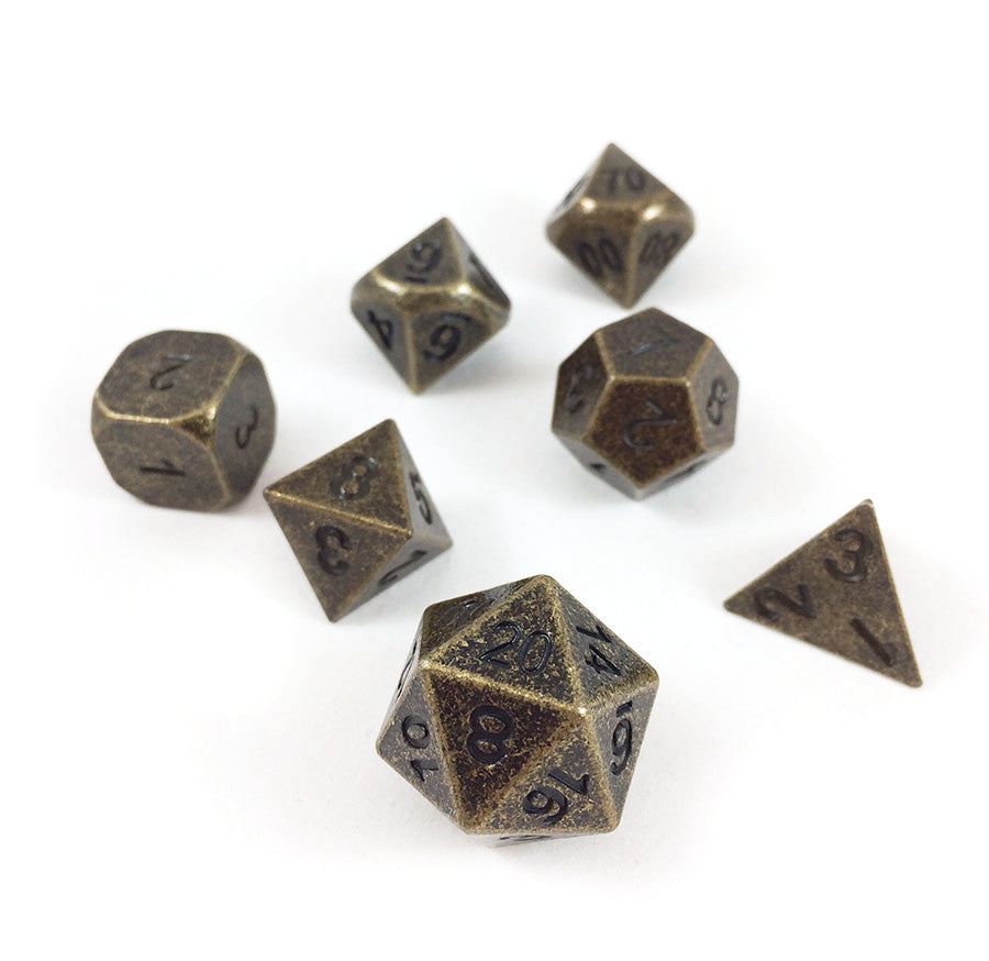 Primordial gold dice set scattered on a white background