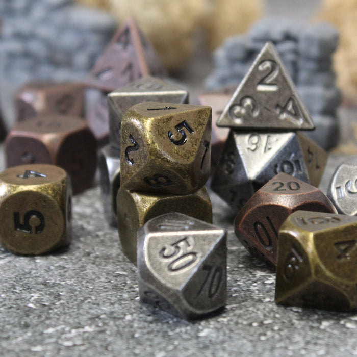 Antique dice sets in classic metallic colors with a weathered, antique treatment and uninked numbers.