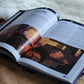Open book with illustrations  of locations for dungeons and dragons including the Maze of the Fey King in 80s Adventures.