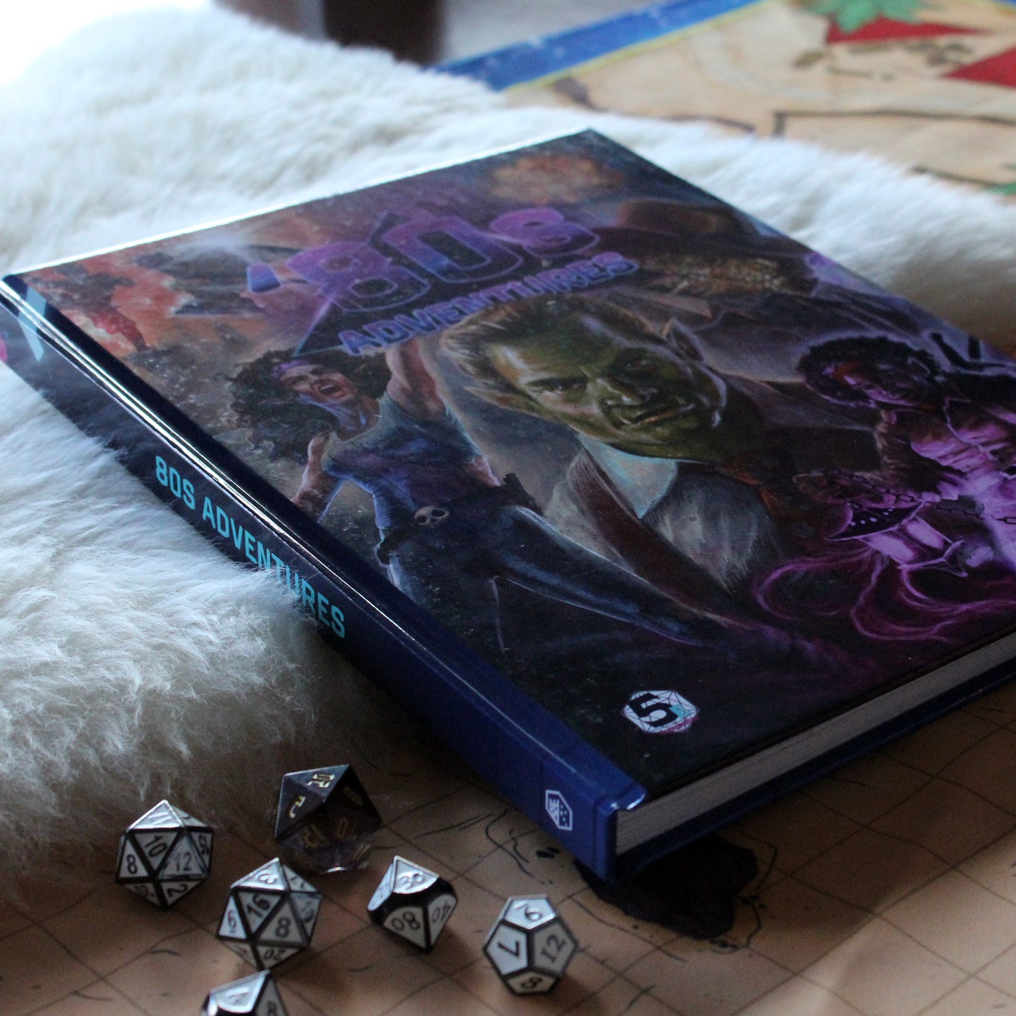 Role-playing game book "80s Adventures" with character illustrations on a surface with dice.