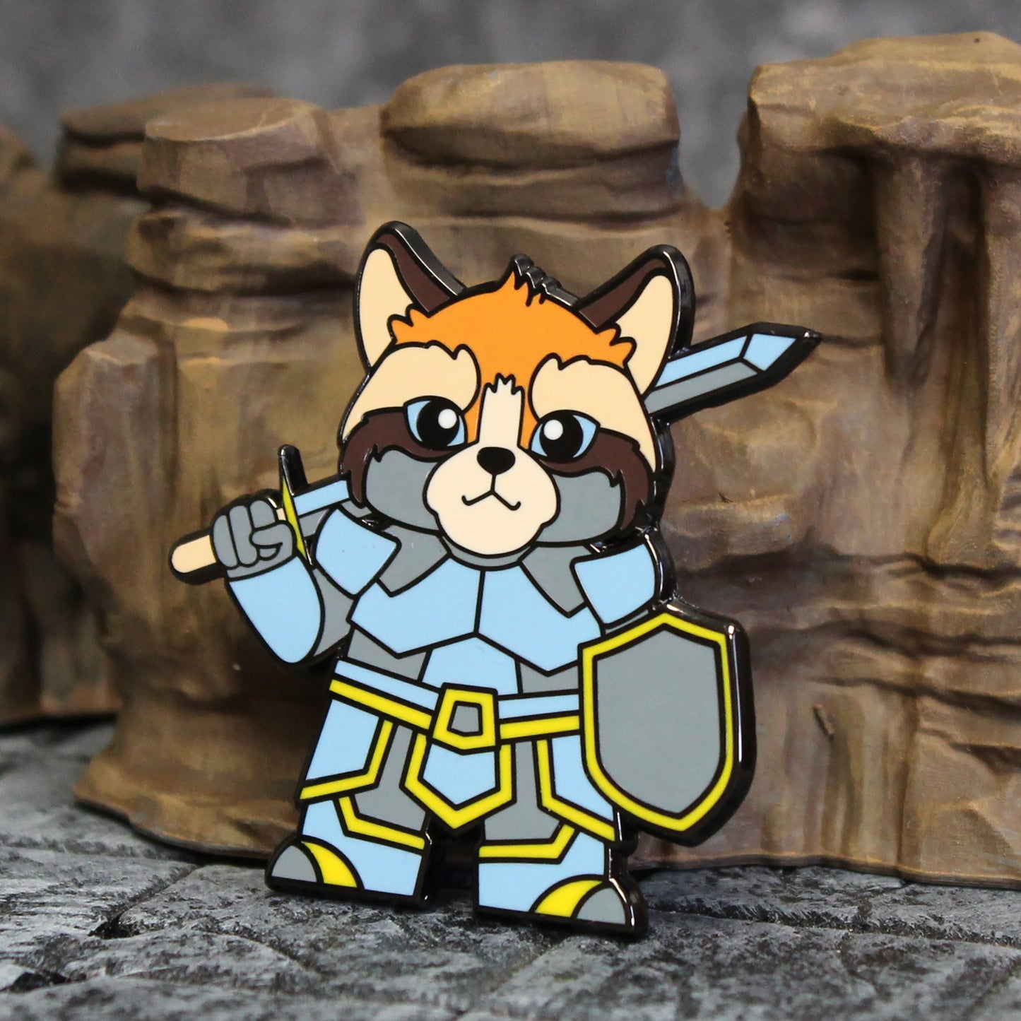 Adventure Cats paladin pin set against a cave backdrop, depicting the armored cat adventurer in a fantasy environment.