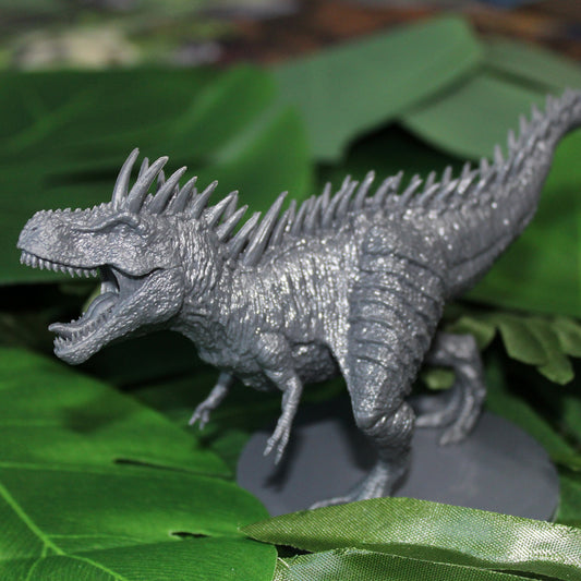 Unpainted trex miniature among green leaves