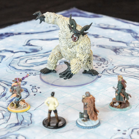 Closeup photo of a snowy battle map with various miniature figures on it