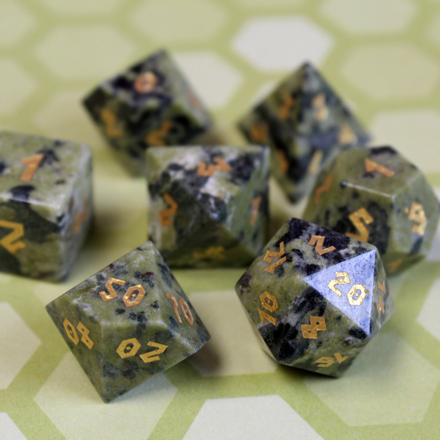 Jade dice set arranged on a table, designed for Dungeons & Dragons and other RPG games.