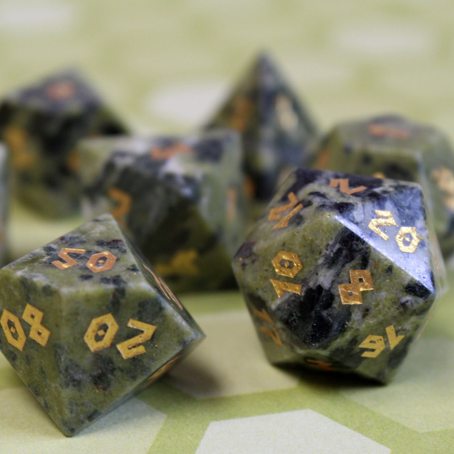 Close-up of Jade D100 with gold numbering on the green to deep green surface colors.