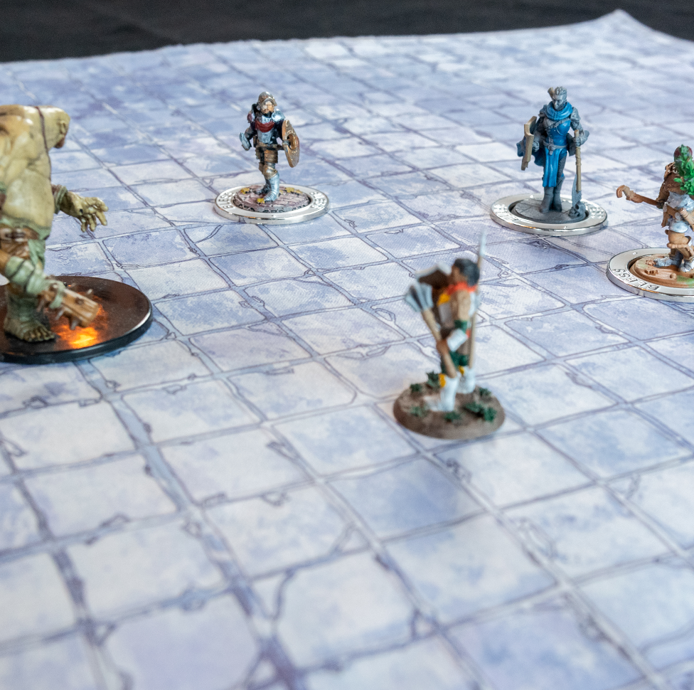 Photo of a castle floor battle map with various miniature figures positioned on it