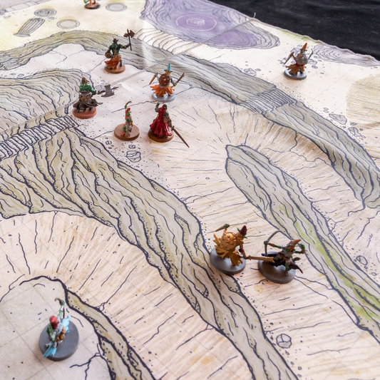 Isometric photo of a cliffside battle map with multiple miniature figures on it 