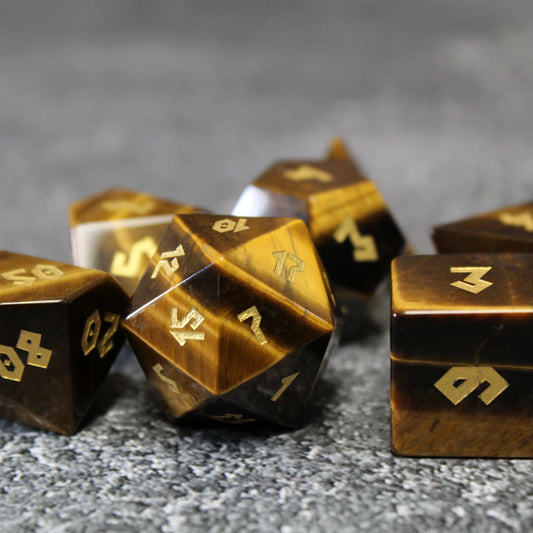 Close-up of the Tiger Eye D20, featuring intricate gold numbering and the unique striations of the gemstone.