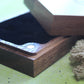 Wooden dice case with magnetic closures on a green surface