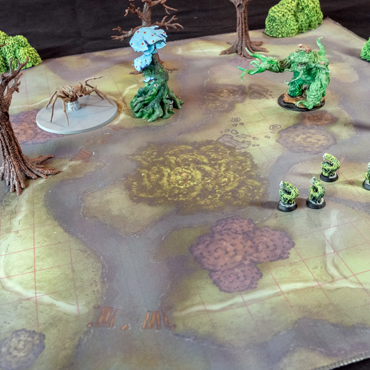 Photograph of a swamp battle map with miniature trees and figures on it.