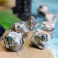 Scattered Dentrite Agate Gemstone Dice Set with a close-up of the unique marbled texture and intricate gold-color numbering.