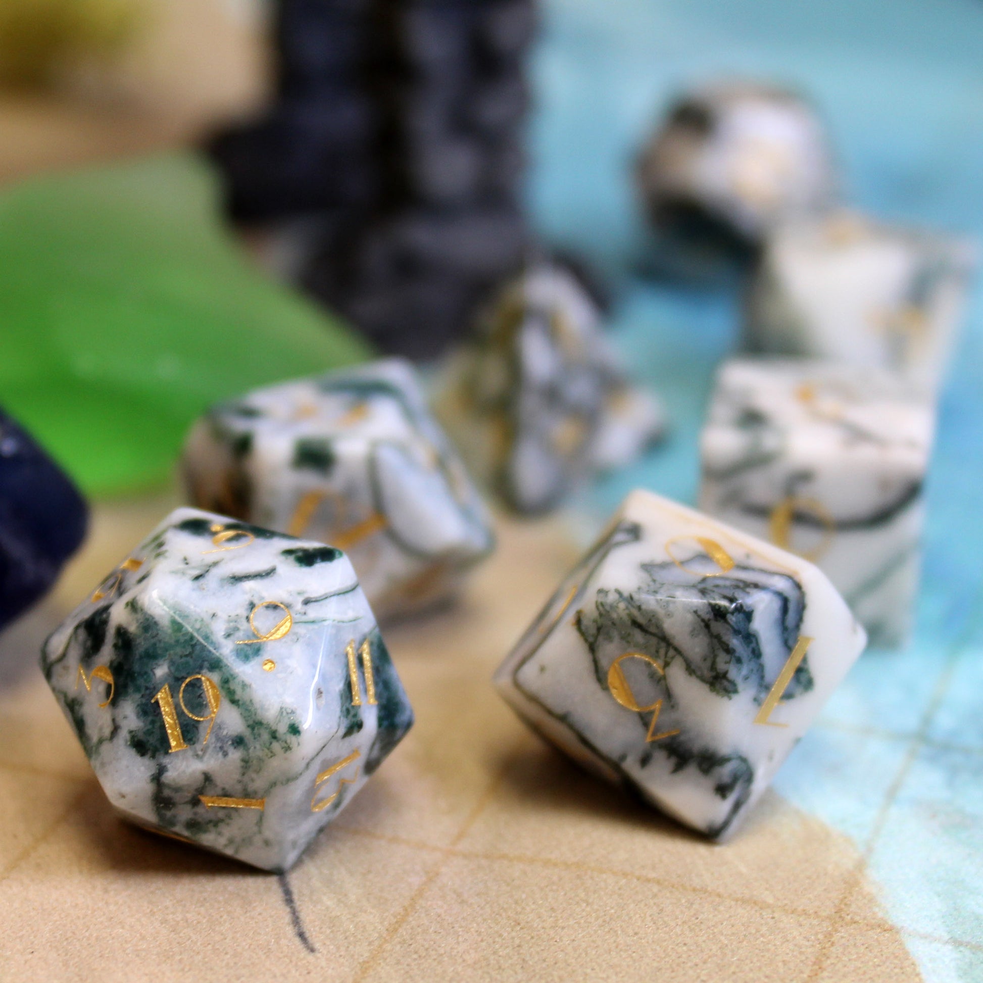 Scattered Dentrite Agate Gemstone Dice Set with a close-up of the unique marbled texture and intricate gold-color numbering.