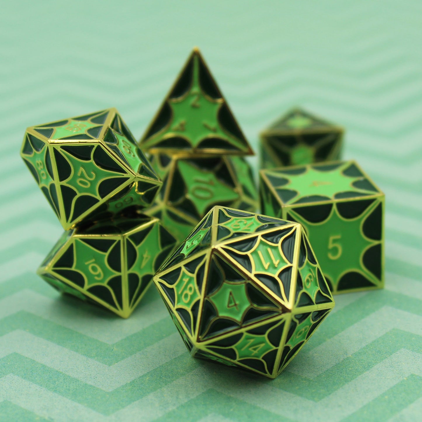 Green dragon pattern metal dice set displayed, showcasing gold finish and deep green enamel for RPG enthusiasts.