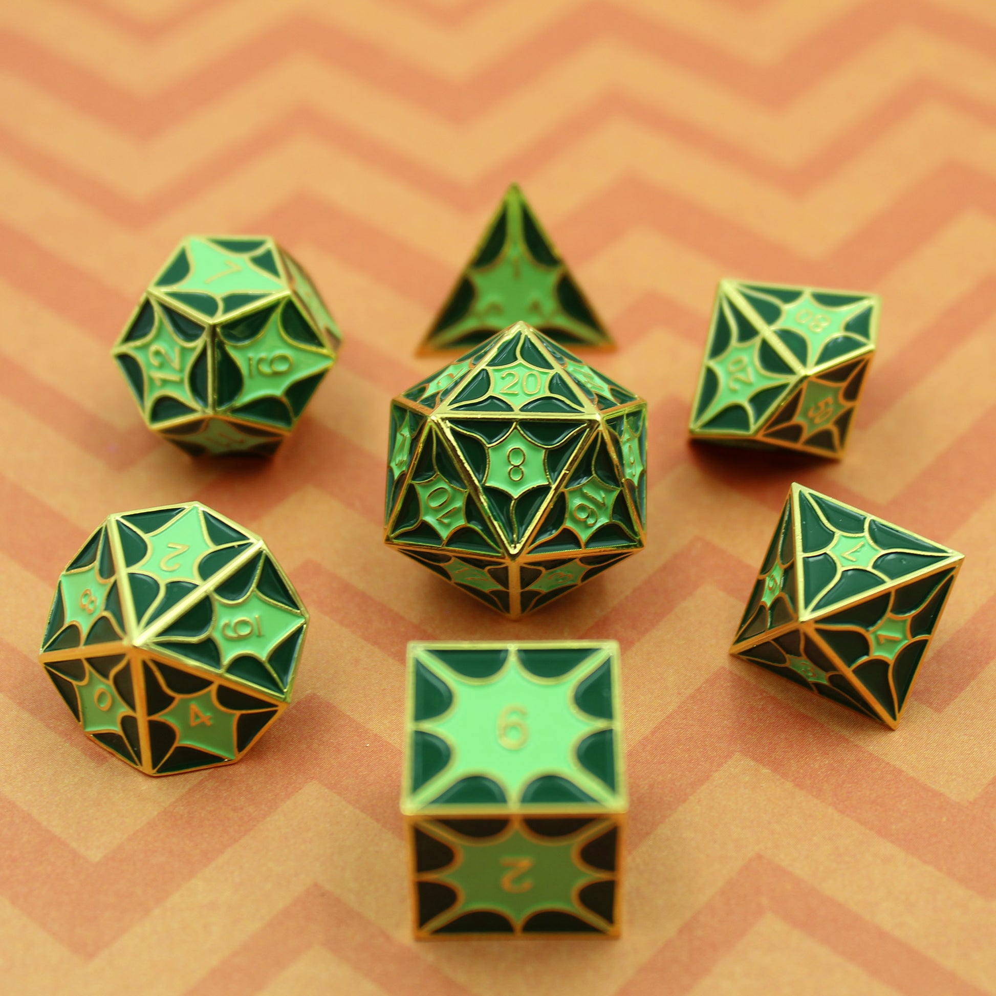 Green metal dice set with dragon pattern, highlighting the gold finish and symmetrical design for tabletop RPGs.