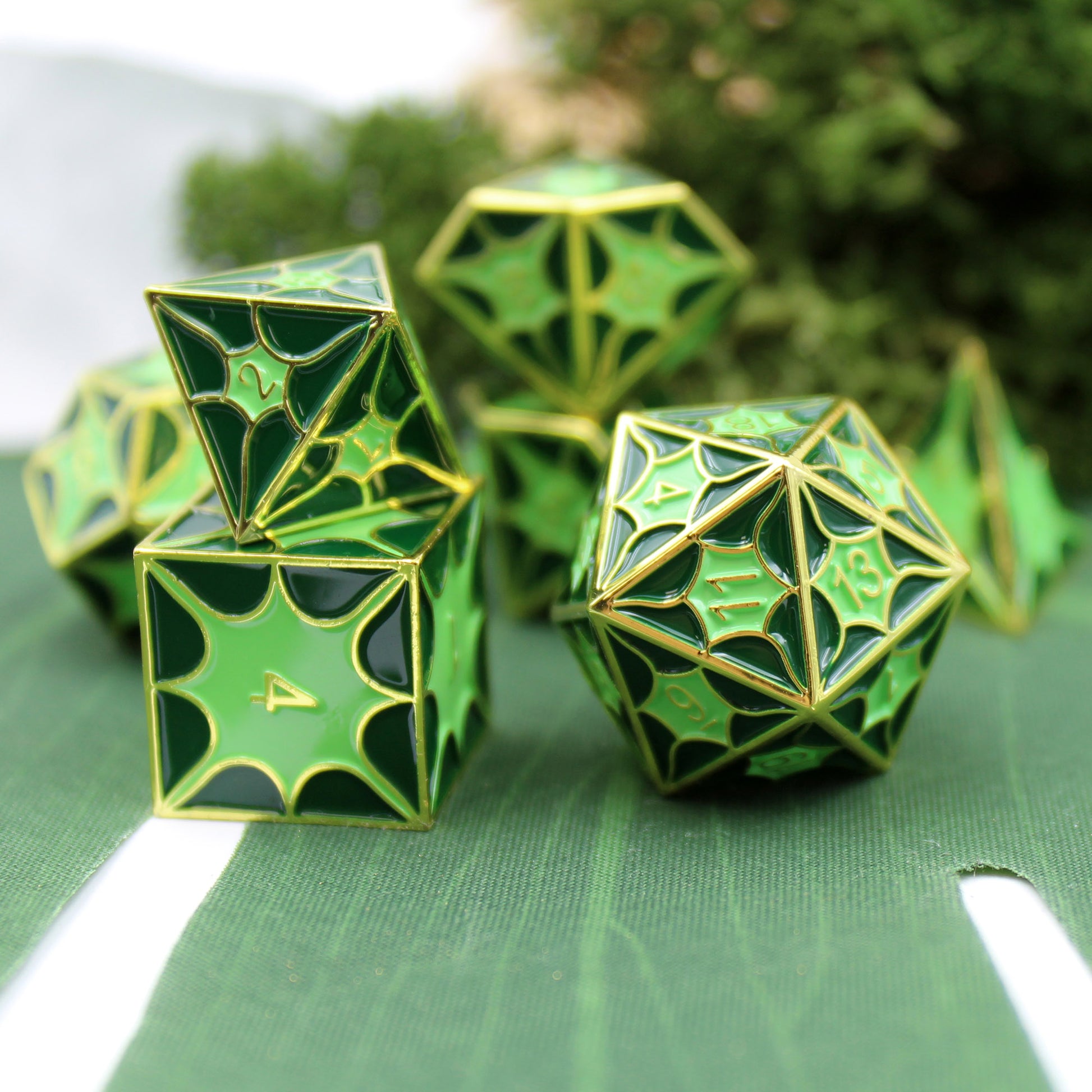 Green dragon pattern metal dice set with gold finish.